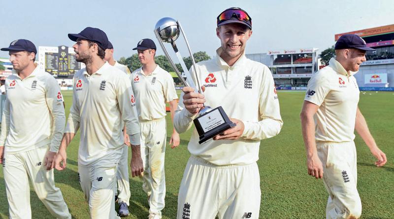 Joe Root leads his triumphant England team out of the SSC ground in Colombo (AFP)  