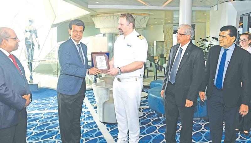 SLPA Chairman  Dr.Parakrama Dissanayake exchanges  plaques with the Master of Mein Schiff 3 -  Capt. Alevropoulos George. Managing Director of Shipping Agency Services, Gihan Nanayakkara looks on.