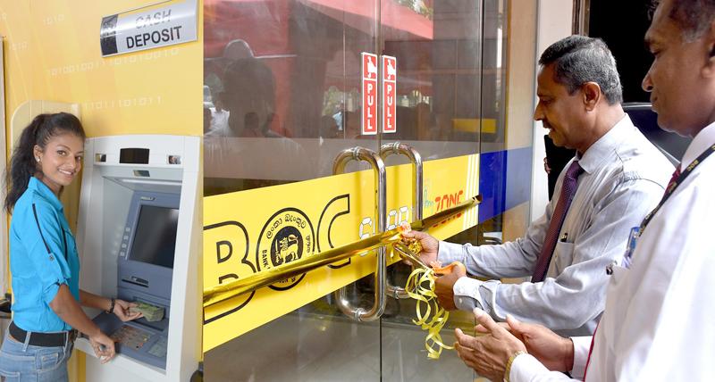 Deputy General Manager Sales and Channel Management C. Amarasinghe opens the 1000th ATM/CDM machine at the Kuliyapitiya second branch. Assistant General Manager North Western Province I.M.L Karunathilake looks on.  
