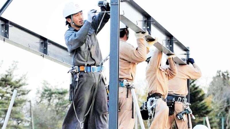 Japan will allow some foreigners to work in construction and other sectors    