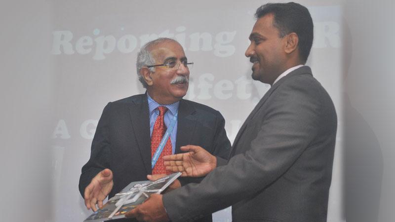 Dr. Achala Jayatilleke handing over the translation to Dr. Patanjali Dev Nayar