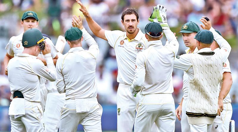 Australia’s fast bowler Mitchell Starc (C) celebrates with teammates after taking the wicket of India’s batsman Murali Vijay (AFP) 