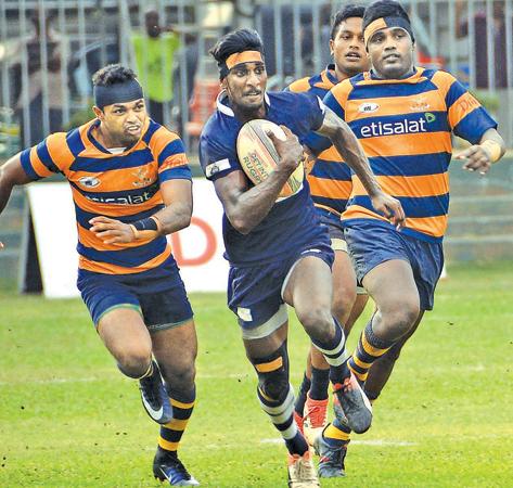 Police player Sachith Silva heads for the try line after beating the Army defence in their Dialog League rugby match yesterday                                                                                                                                                                                                (Picture by Saman Mendis)   