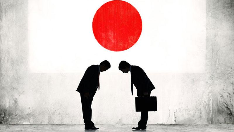 Two businessmen greet each other in Japan