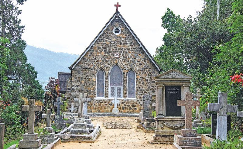 A front view of the stone built Warleigh Church amidst surrounding tombstones