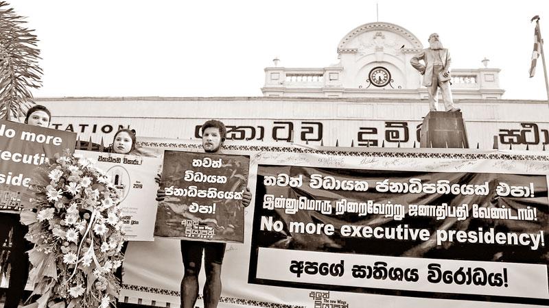 Placard bearing Aluth Piyapath activists at the Fort Railway Station