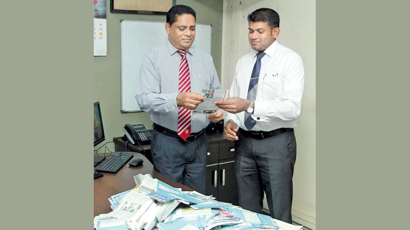 Deputy General Manager Finance, Virajith Shamendra Bois and Manager Advertising Suranga Dalugoda selecting the Readers Coupon No.8 winners of Observer - Mobitel School Cricketer 2018 at Lake House. Pic by Shan Rambukwella 