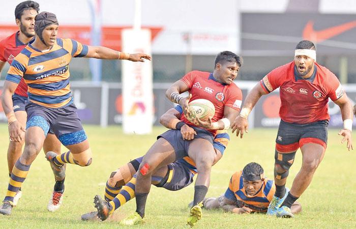 CR full back Kevin Dixon is held by an Army defender    Pic: Saman Mendis   