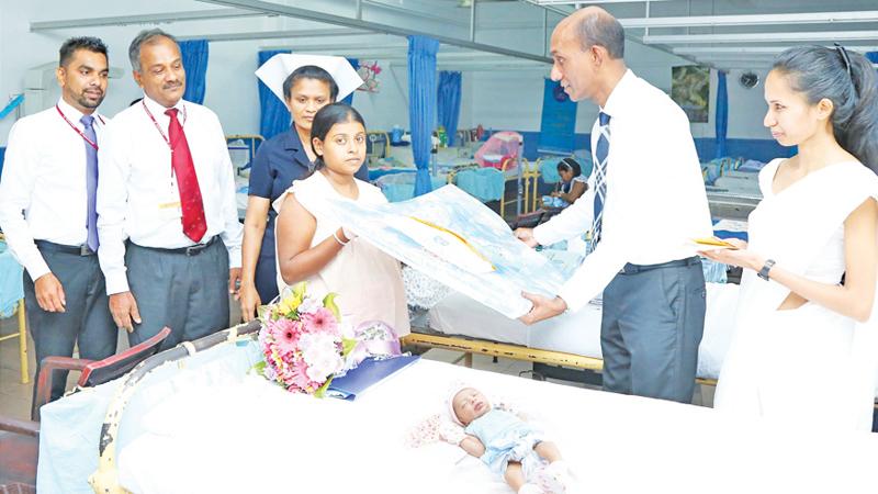 Chief Executive Officer and General Manager-Designate Rasitha Gunawardena presents a gift to a newborn baby at the De Soysa Hospital for Women in Borella.   