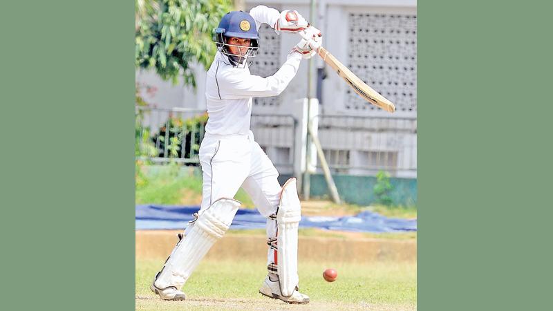 Nalanda College batsman Chamindu Wijesinghe drives a ball on his way to a half century against Maliyadeva College at Campbell Place yesterday   