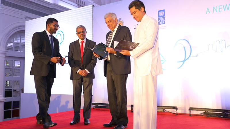  Prime Minister Ranil Wickremesinghe and Non-Cabinet Minister Sujeewa Senasinghe leaf through the First Year Review.        