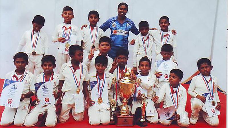 The champion CCC School of Cricket team comprising Tharun Ariyaratne Thesika Goonetilleke, Jahan Pathirana, Tharun Munaweera, Thanuk Mindaka, Methuka Galapitage, Nesandu Adambarage, Sinura Edirisinghe, Aiden Amaraweera, Dillow Ranaraj, Biddhija Atapattu, Vohara Kumanayake, Senuja Wanninayake, Niven Mendis and Uditha Navaratne with coach Rangika Fernando and the trophy