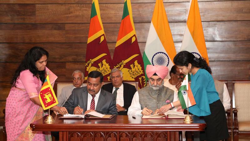 Signing of the MoU by High Commissioner of India to Sri Lanka Taranjit Singh Sandhu and Secretary, Ministry of Development Strategies and International Trade, S. T. Kodikara at Temple Trees while Prime Minister Ranil Wickremesinghe and Minister of Development Strategies and International Trade, Malik Samarawickrema look on.  