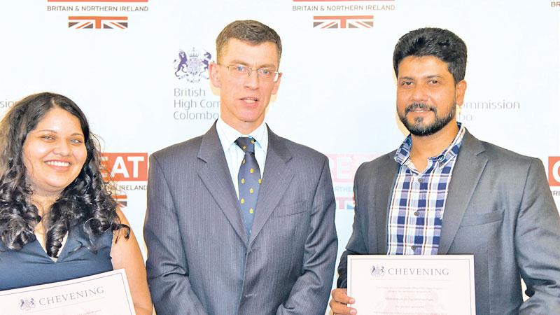 Raisa (L) and Mathanavasam (R) with UK High Commissioner James Dauris
