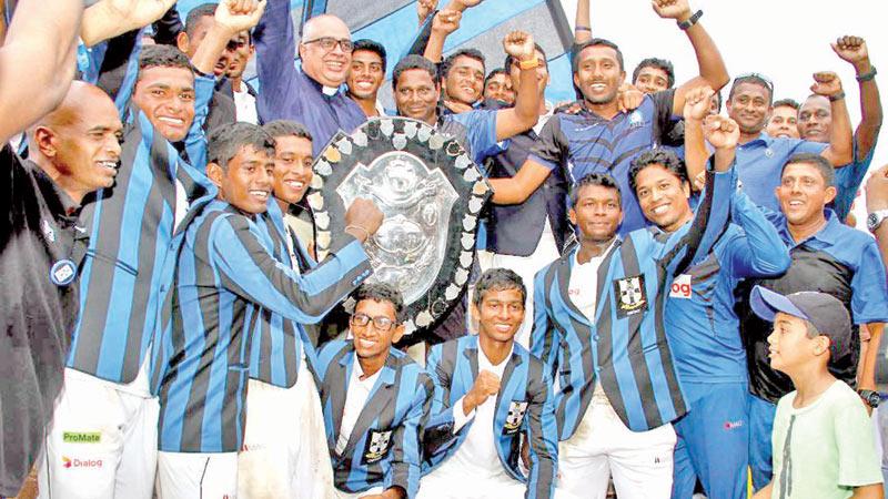 The victorious S. Thomas’ College team celebrate winning the DS Senanayake Shield after beating Royal College in the 140th Battle of the Blues match at the SSC ground yesterday (Pix by Sulochana Gamage and Saman Mendis)