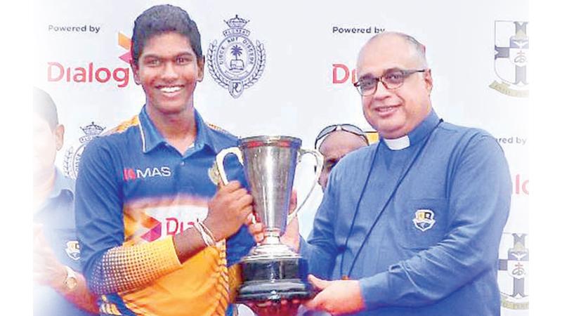 Royal College captain Kavindu Madarasinghe receives the Mustangs trophy from the warden of S. Thomas’ College Rev Marc Billimoria