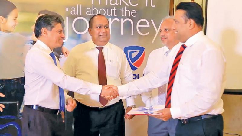 People’s Bank CEO/GM N. Vasantha Kumar, People’s Leasing & Finance CEO Sabry Ibrahim and People’s Insurance CEO  Deepal Abeysekera present the People’s Travelsmart Insurance Policy to Finlay’s Insurance Broker’s CEO Sanjiv Keerthiratne.