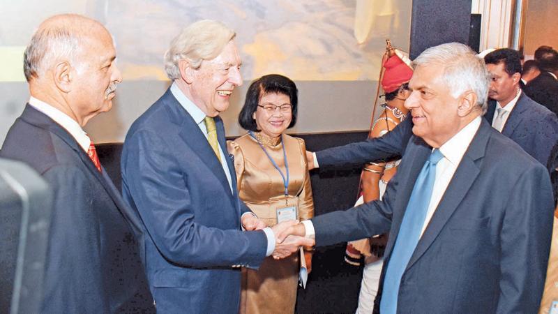 Prime Minister Ranil Wickremesinghe greets Asia-Europe Political Forum (AEPF) co-chairperson Geoffrey Van Orden at the third meeting of the AEPF at the Hilton Hotel yesterday.