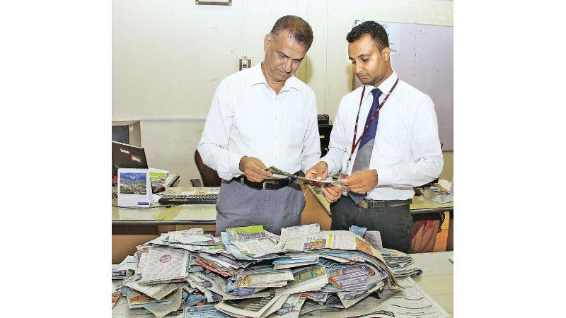 P.G.K. Madusanka, Manager Credit Control (right) and B.K.A. Senaka, Deputy Production Manager doing the draw of the winners at Lake House office.