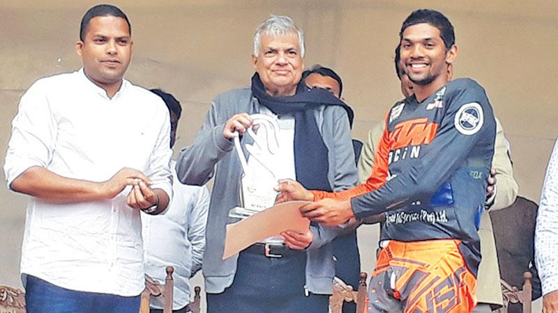 Champion Rider Jacques Gunawardena receiving the coveted Trophy from chief guest Prime Minister Ranil Wickramasinghe and guest of honour Sports Minister Harin Fernando