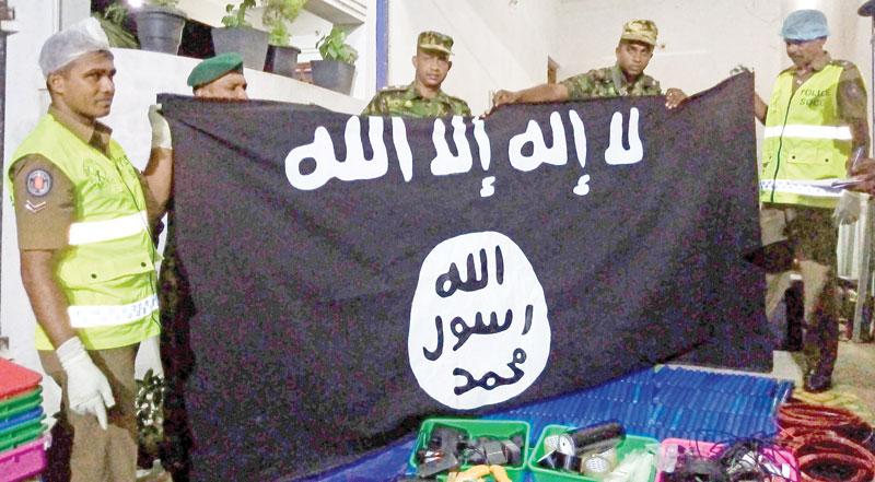 Security personnel display seized items after they raid what believed to be an Islamist safe house in the eastern town of Kalmunai. - Fifteen people, including six children, died during a raid by security forces as three cornered suicide bombers blew themselves up and others were shot dead, police said on April 27. AFP