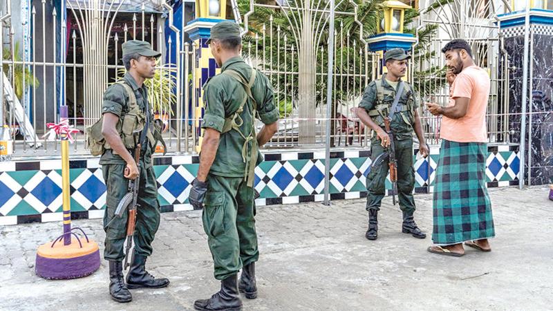 Soldiers standing guard outside a mosque in Kattankudy. Photo Courtesy: New York Times