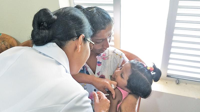 A little girl is given the MMR vaccine