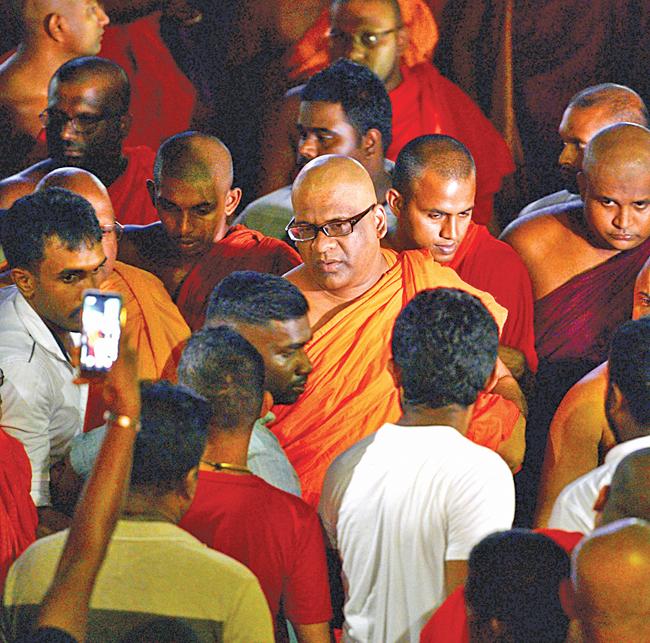 General Secretary of the Bodu Bala Sena (BBS) Ven. Galagodaatte Gnanasara (C) leaves after a meeting with Buddhist spiritual leader Ittapana Dhammalankara Anu Nayake Maha Thera at the Rukmalgama Temple in Rukmalgama, about 20 kms from Colombo on May 23, 2019. (Pic: Ishara S.  Kodikara / AFP)