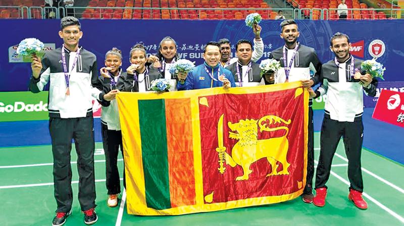 The Sri Lanka badminton team which became group champions pose with their medals. From left: Buwaneka Gunatilleka, Kavidi Sirimannage, Thilini Hendahewa, Dilmi Dias, Tony Wahyudi (coach), Mahinda Gamage, Sachin Dias and Dinuka Karunaratna