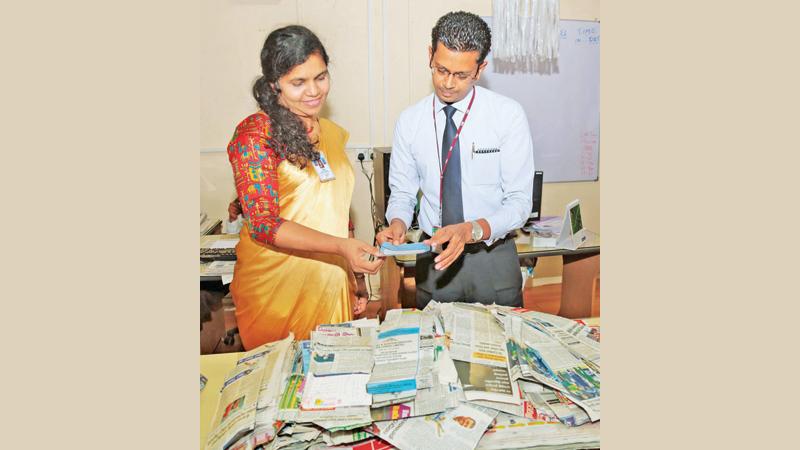  Manager – Learning & Development Nipuna Liyanage (left) and Deputy Manager Human Capital Udeni Indika Jayamaha selecting the Readers Coupon No.29 winners of Observer - Mobitel School Cricketer 2018 at Lake House.  Pic: Shan Rabukwella