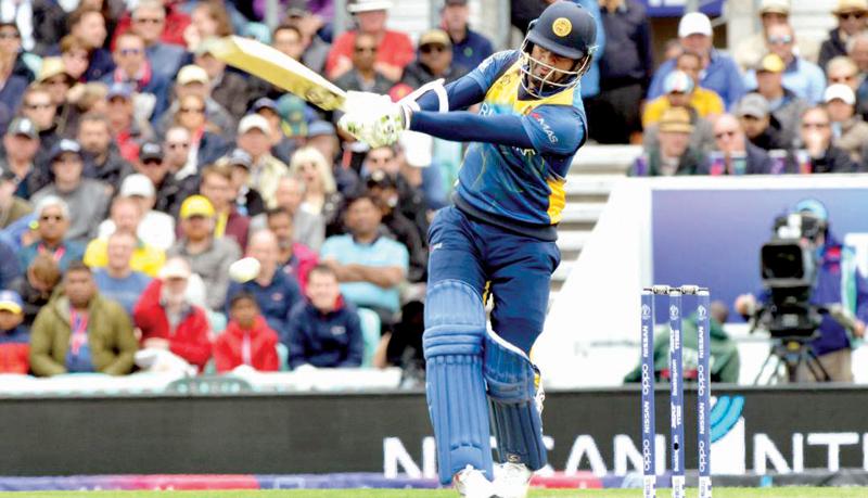 Dimuth Karunaratne drives a ball during his innings of 97 against Australia in Sri Lanka’s World Cup match at the London Oval yesterday  Pic: Kamal Jayamanne     