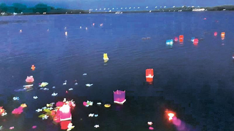 Candles and flowers picked from the gardens of the little ones of BEYS float at the Batticaloa lagoon