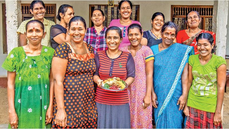 Merin Kalpana(C) and members of the Valalai Women’s Rural Development Society pose for a picture