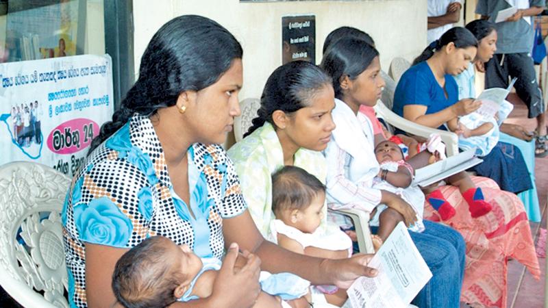 Mothers waiting at a primary medical care facility to vaccinate children