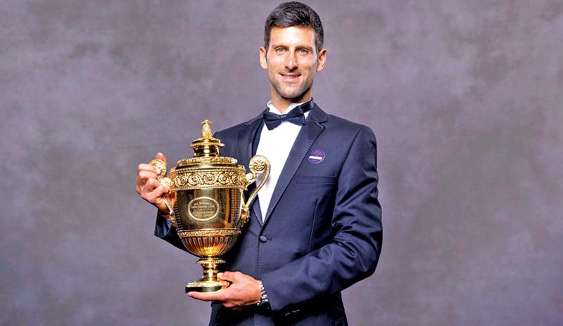 2019 Wimbledon Men’s singles champion Serbia’s Novak Djokovic posing for a photograph with his trophy (AFP)