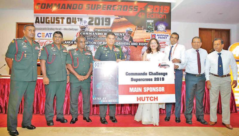 Chief of Staff and Center Commandant Commando Regiment Shavendra Silva accepting the main sponsorship for the Commando Challenge Super Cross from Ramzeena, Lye head of Sales and Marketing Hutchison Telecommunication Lanka. Also in the picture is Commandant Commando Base Ganemulla Brigadier Shamal Silva. Picture by Rukmal Gamage