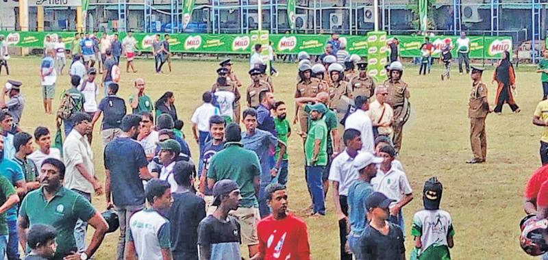 Anti-riot policemen move onto the ground at the Royal Sports Complex to control violence at last week’s match between Isipathana and St. Peter’s    