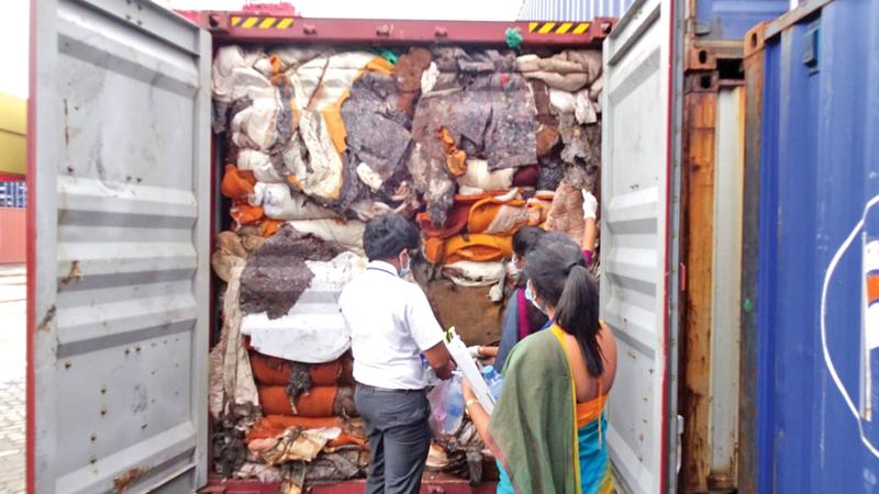 Customs officials inspecting the containers of garbage