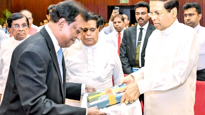 President Maithripala Sirisena receives the first copies of the books from the Chairman, Sri Lanka Foundation, Sarath Kongahage and Chief Editor K. Ariyatunga   