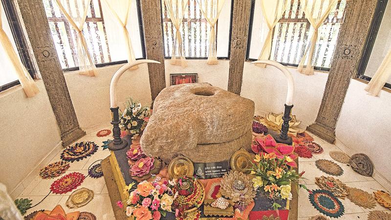 The sacred Grinding Stone displayed in the temple for public veneration