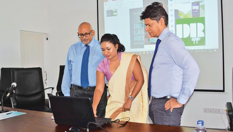 YAU Medhavi (centre) IT Officer of the Sr Lanka Anti Doping Agency launches the anti-drug App called Drug Reference App or DR App in the presence of Chairman the Sri Lanka Anti Doping Agency professor Arjuna de Silva (right) and the Director General of SLADA Dr. Seevali Jayawickrama at its auditorium