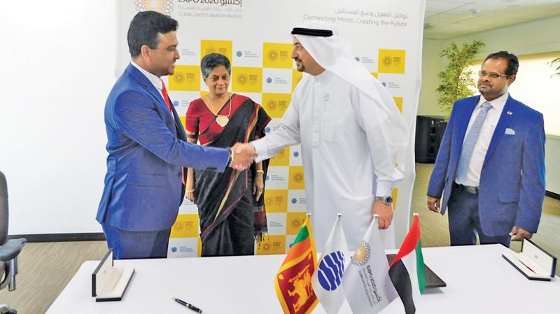 Deputy Minister of Development Strategies and International Trade, Nalin Bandara greets a Dubai Expo official at the contract signing ceremony. 