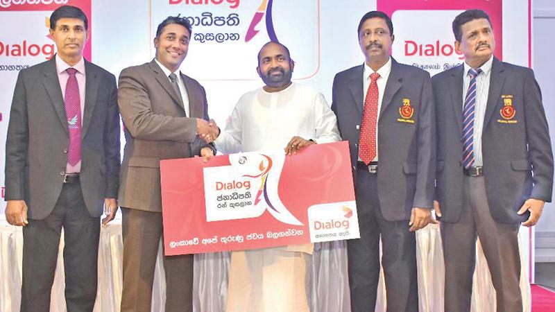 Harsha Samaranayake the Senior General Manager - Brand and Media of Dialog, presents the sponsorship cheque to Ranjith Siyambalapitiya MP and president of the Sri Lanka Volleyball Federation as AS Nalaka, General Secretary of the Sri Lanka Volleyball Federation looks on