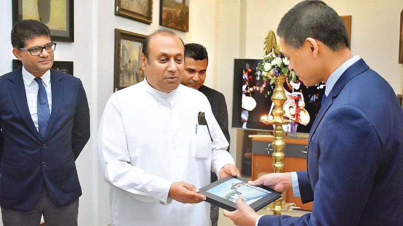 Mayor of Kandy, Kesara Senanayake receiving a photo book from Chathura Dissanayake, Director / CEO of Ranpath Group of Companies   