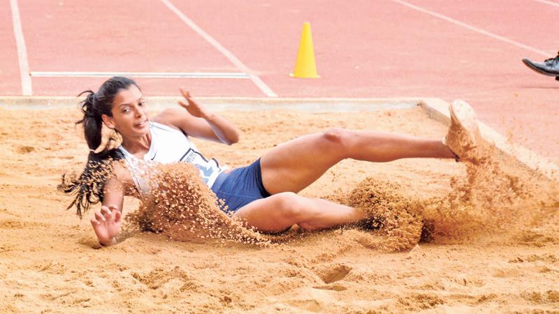 Army athlete HDV Lakshani makes a long jump to victory with a distance of 6.23 metres at the 97th Athletic Nationals at the Sugathadasa Stadium in Colombo yesterday (Pix by Ranjith Asanka)