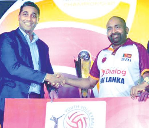 Senior Manager Marketing and Branding Dialog Axiata, Harsha Samaranayake (left) presents the sponsorship to the president of the Sri Lanka Volleyball Federation Ranjith Siyambalapitiya at the launch of the Junior Volleyball Championship at the BMICH on Thursday. Picture by Ranjith Asanka