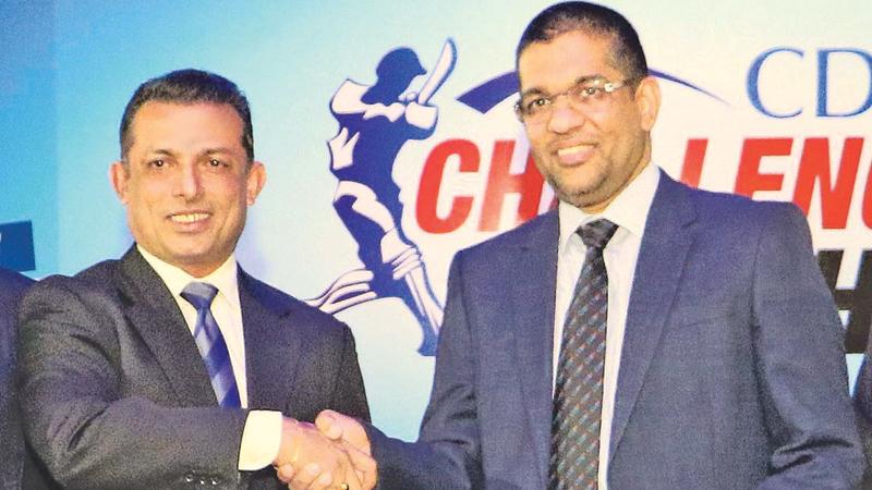 Mercantile Cricket Association president Roshan Iddamalgoda (left) receiving the sponsorship package for the CDB Challenge Trophy Cricket Sixes from Damith Tennekoon Director and Deputy CEO of Citizens Development Business Finance PLC . Pic:Saman Sri Wedage