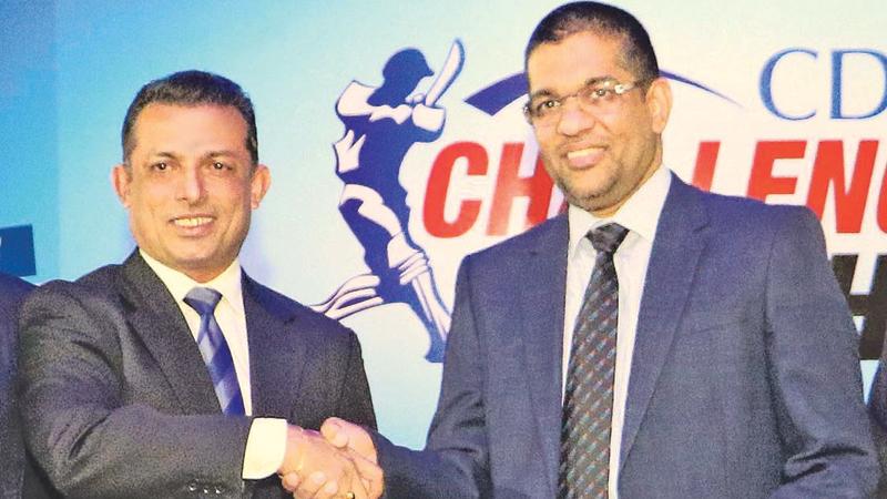 Mercantile Cricket Association president Roshan Iddamalgoda (left) receiving the sponsorship package for the CDB Challenge Trophy Cricket Sixes from Damith Tennekoon Director and Deputy CEO of Citizens Development Business Finance PLC . Pic:Saman Sri Wedage  