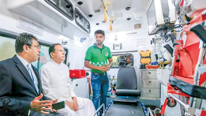 President Maithripala Sirisena and Subject Minister Dr Harsha De Silva inspecting a 1990 ambulance.
