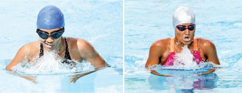 Musaeus College’s Liyara Gunapala (left) and Ramidu Samarakoon from Visakha Vidyalaya compete in the breaststroke at the Milo Sri Lanka Schools Swimming Championships at the Sugathadasa Stadium pool in Colombo yesterday. (Pic by Saman Mendis) 